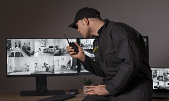 portrait male security guard with radio station camera screens 1